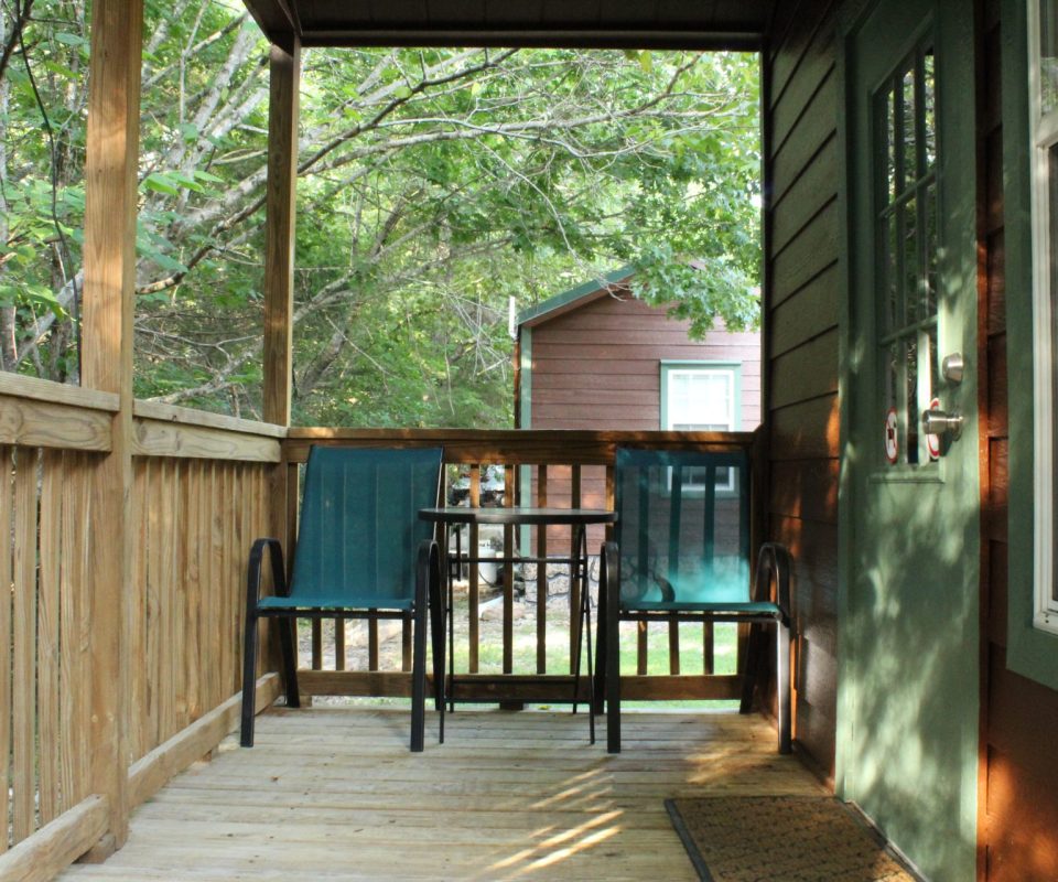 porch view with chairs of cabin at Great Escapes RV Resorts Branson