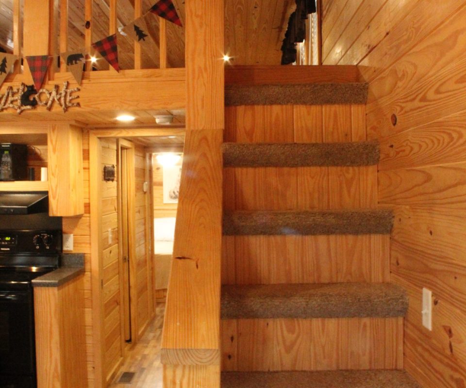 stairs leading to loft in cabin at Great Escapes RV Resorts Branson