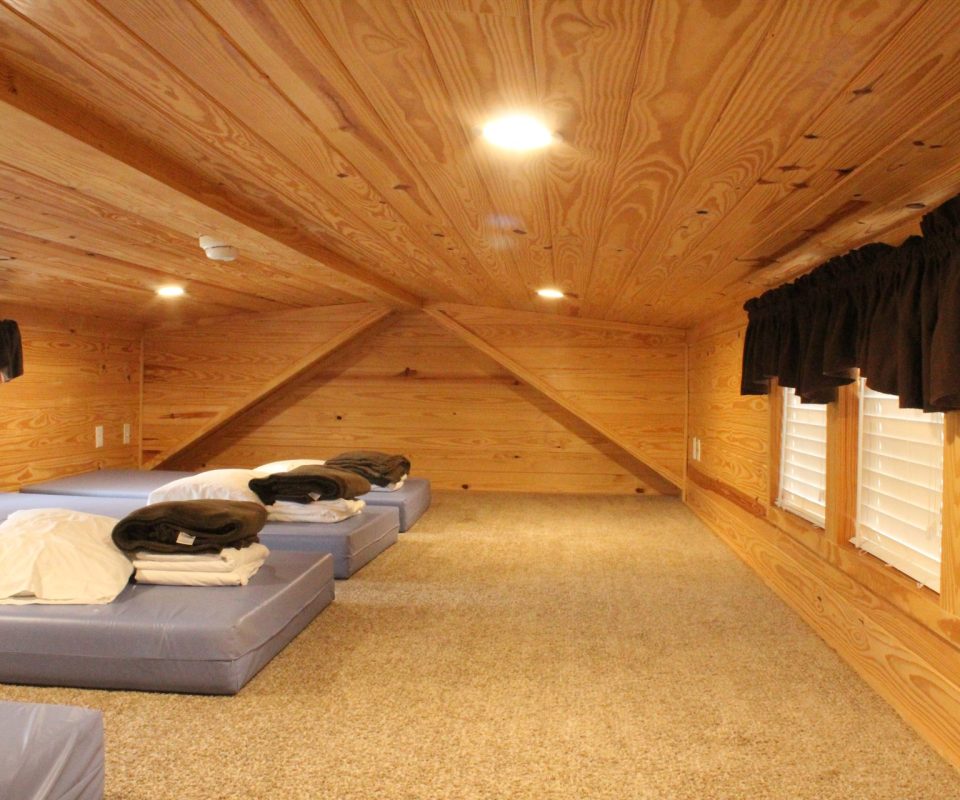 loft sleeping area with beds in cabin at Great Escapes RV Resorts Branson