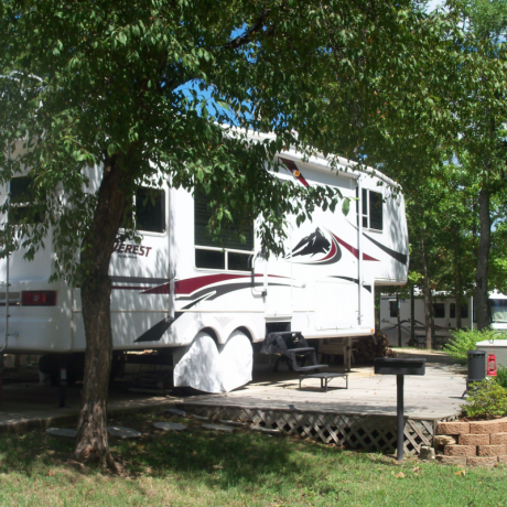 parked rv with tree and grass
