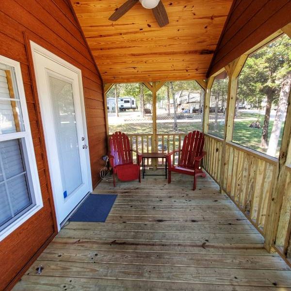 cabin porch with seating at Great Escapes RV Resorts Branson