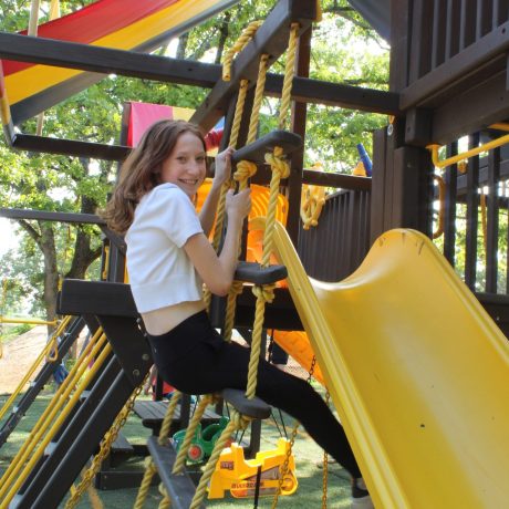 girl climbing up playset at Great Escapes RV Resorts Branson