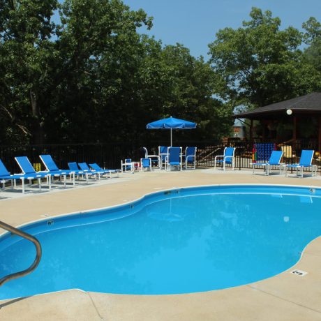 resort style pool with lounging area | amenity at Great Escapes RV Resorts Branson MO