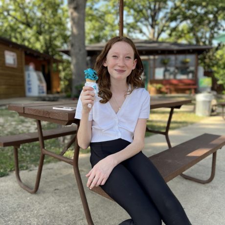 girl eating ice cream and sitting at a picnic table at Great Escapes RV Resorts Branson